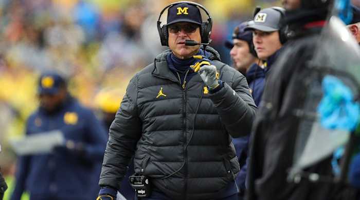 Michigan head coach Jim Harbaugh looks on while coaching during a game.